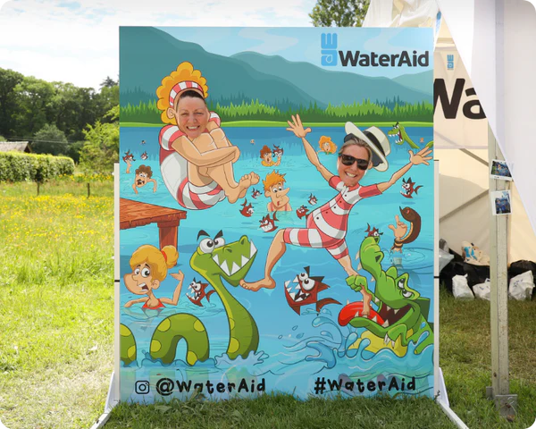 Custom face-in-hole photo board at an outdoor charity event